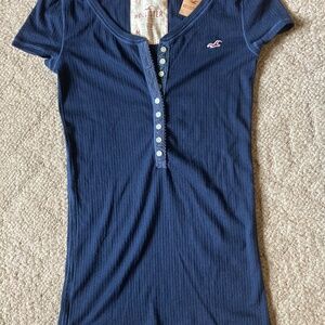 Woman’s top, navy blue color, Hollister brand. Half button top(9 buttons).Medium